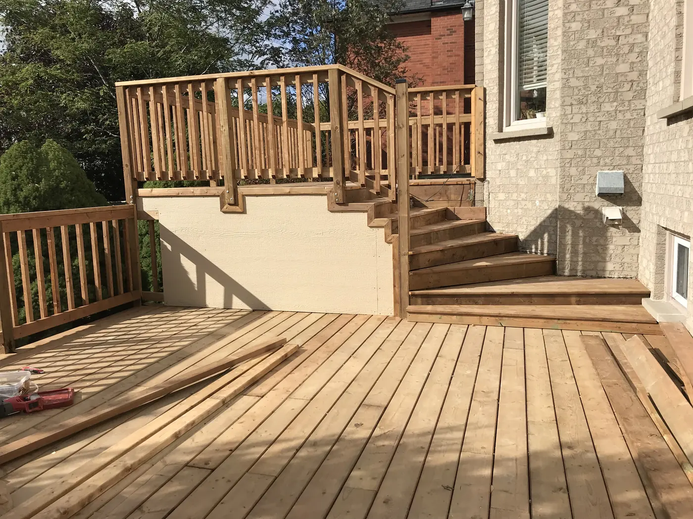 Lower and upper deck levels joined by wide wood stairs in Markham