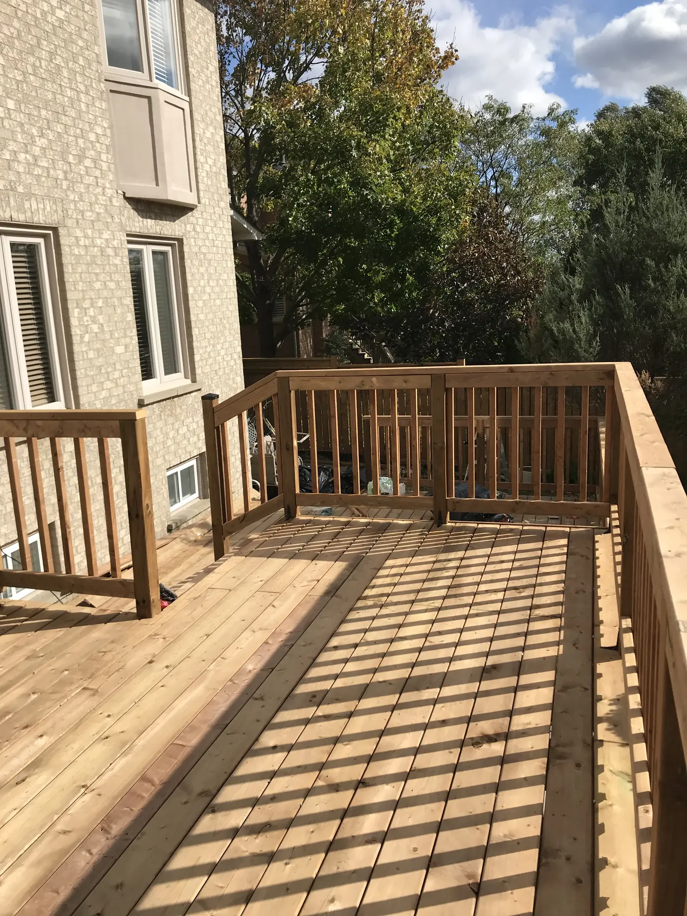 Deck walkway with wood picket railings along a Markham home