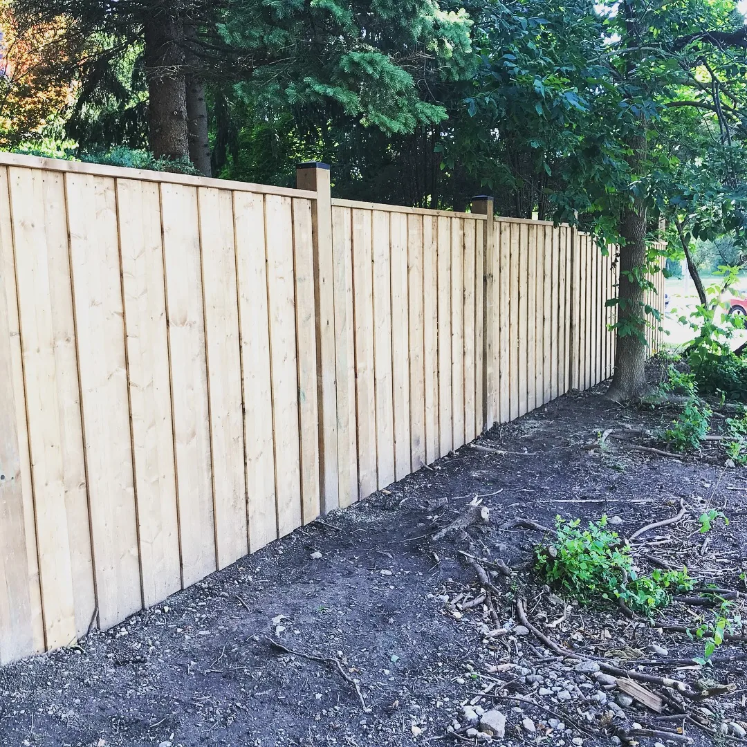 New 100 ft pressure-treated wood privacy fence with 6x6 posts and post caps in Toronto