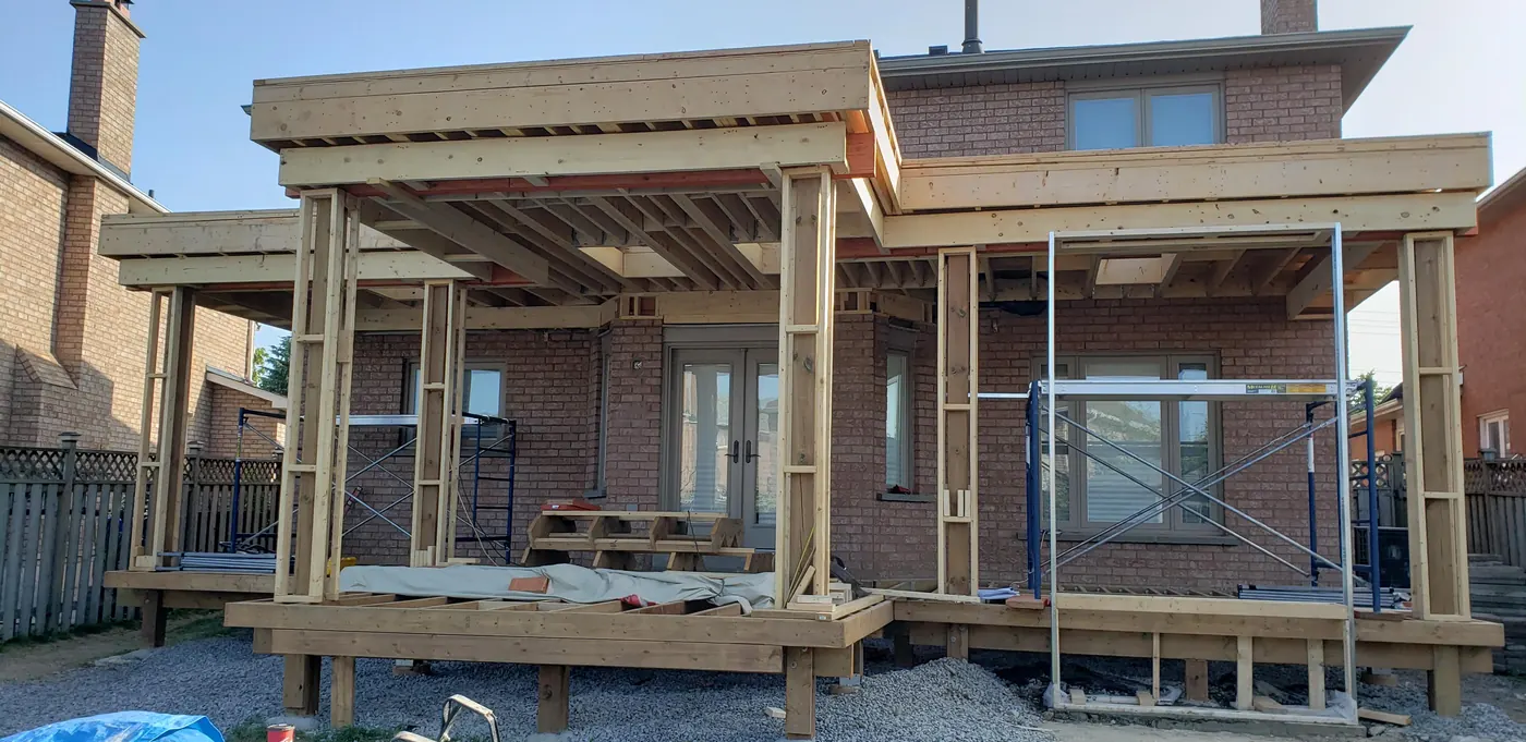 Framed covered deck structure with posts wrapped before finishing in Vaughan